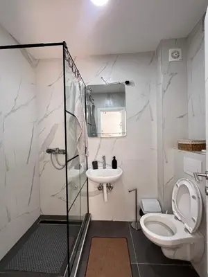 a bathroom with a toilet and a sink at KopStar Apartment Kopaonik 19 in Kopaonik