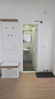 a bathroom with a sink and a bench in a room at KopStar Apartment Kopaonik 19 in Kopaonik
