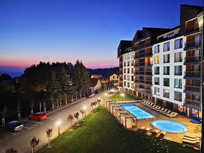 an aerial view of a building with a swimming pool at VAB Apartments & SPA, Residence hill, Kopaonik in Kopaonik