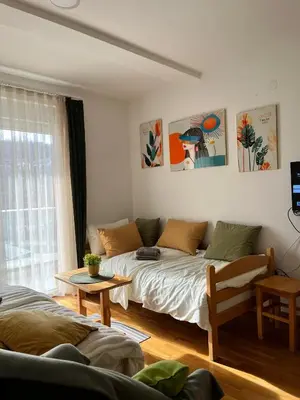 a living room with a bed and a couch at Apartman Green in Vrnjačka Banja