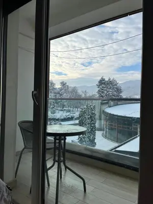 a view of a balcony with a table and a window at Apartman Green in Vrnjačka Banja