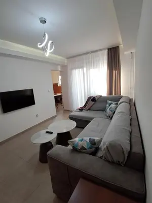 a living room with a couch and a table at Zenit apartmani in Niš