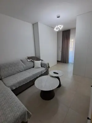 a living room with a couch and a table at Zenit apartmani in Niš