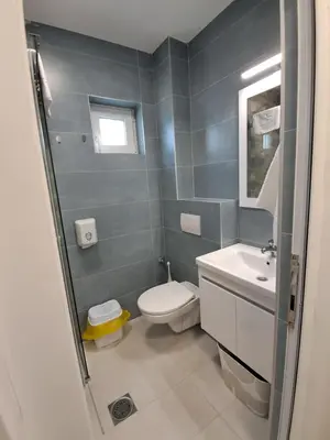 a bathroom with a toilet and a sink at Zenit apartmani in Niš