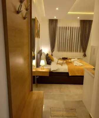 a bedroom with a large bed and a window at Nlux 30 MamaBaba Resort&Spa in Kopaonik