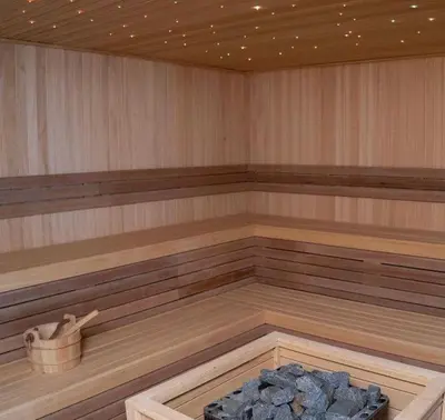 a large empty sauna with a stone in the middle at Nlux 30 MamaBaba Resort&Spa in Kopaonik