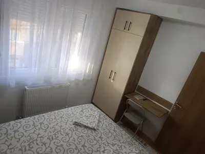 a small bedroom with a bed and a dresser at Apartman Petar i Dunja in Vranje