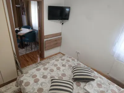 a bed with two pillows on it in a room at Apartman Petar i Dunja in Vranje
