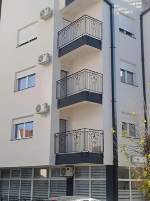 an apartment building with balconies on the side of it at Apartman Petar i Dunja in Vranje