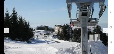 a ski lift on top of a snow covered slope at Sunčani Breg app 8 in Kopaonik