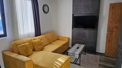 a living room with a couch and a table at Sunčani Breg app 8 in Kopaonik