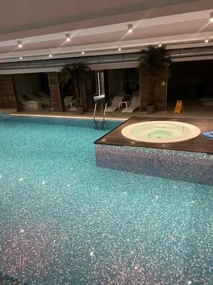 a large swimming pool in a hotel with a large tub at Sunčani Breg app 8 in Kopaonik