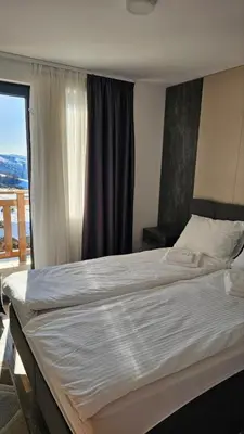 a large bed in a room with a window at Sunčani Breg app 8 in Kopaonik