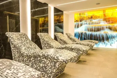 a row of chairs in a room with a painting at Apartman Alastra AP 02 President Kop in Kopaonik
