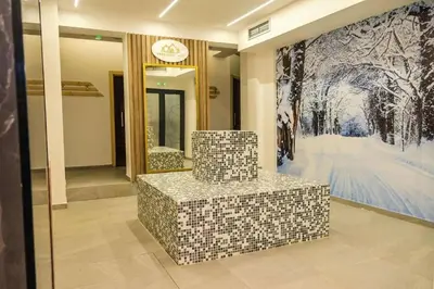 a lobby with a tile bench in front of a painting at Apartman Alastra AP 02 President Kop in Kopaonik