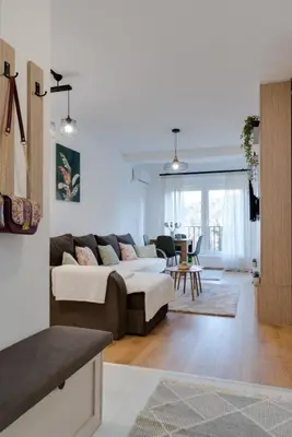 a living room with a couch and a table at Apartman Svitanje Vrnjacka banja in Vrnjačka Banja
