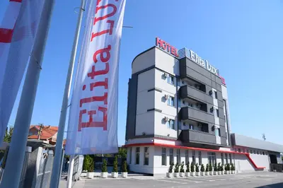a building with a sign on top of it at Garni Uni Elita Lux Hotel in Niš