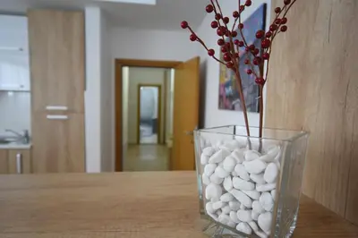 a vase filled with white rocks sitting on a table at Garni Uni Elita Lux Hotel in Niš