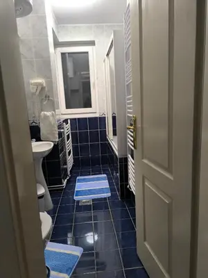 a bathroom with a sink and a blue tiled floor at Apartman Plava nota in Vrnjačka Banja
