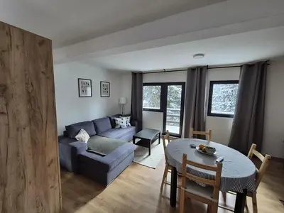 a living room with a couch and a table at Mountain Nook in Kopaonik