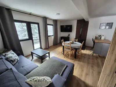 a living room with a couch and a table at Mountain Nook in Kopaonik