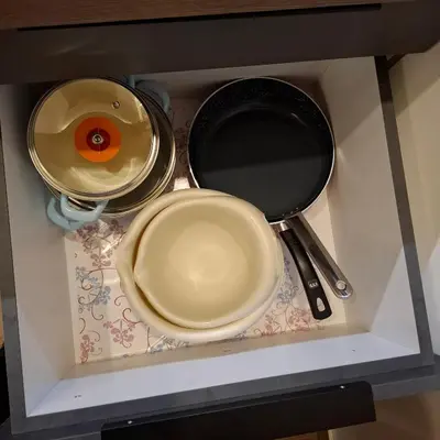 a shelf with three pans and a plate and utensils at Deluxe Mountain View Studio ViS in Residence Hill Hotel Kopaonik in Kopaonik
