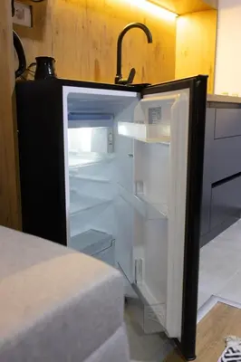 an empty refrigerator with its door open in a kitchen at Porta Porta 22 Kopaonik - free garage in Kopaonik