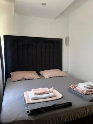 a bed with two towels on top of it at Aurora Nis in Niš