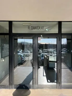 a store front with the entrance to a parking lot at Aurora Nis in Niš
