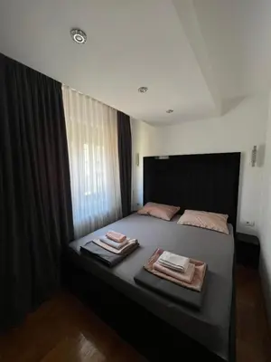 a bedroom with a bed with two towels on it at Aurora Nis in Niš