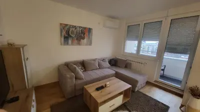 a living room with a couch and a coffee table at Konatar Apartmants in Kruševac