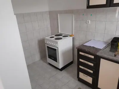 a small kitchen with a stove and a counter at Nebo in Soko Banja
