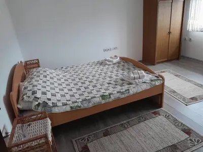 a bedroom with a bed in a room with rugs at Nebo in Soko Banja