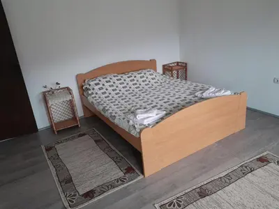 a bed with a wooden frame in a room at Nebo in Soko Banja