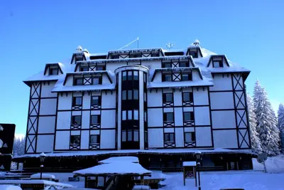 a large building with snow on it at Vila Nikola 202 centar in Kopaonik