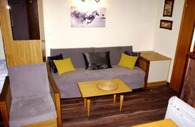 a living room with a couch and a table at Vila Nikola 202 centar in Kopaonik