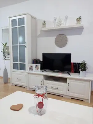 a living room with a tv and a white cabinet at Nektar 88 Lux in Vrnjačka Banja