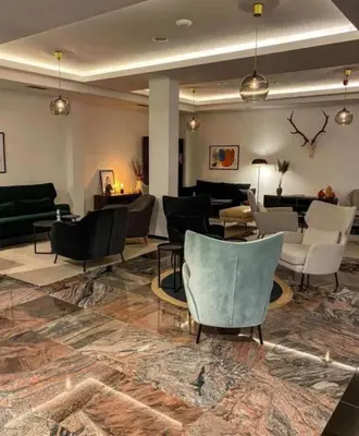 a lobby with couches and chairs in a room at Nektar 88 Lux in Vrnjačka Banja