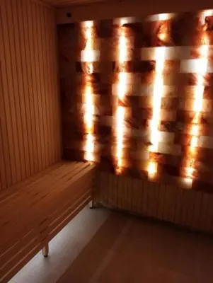 a wooden bench in a room with a wooden wall at Nektar 88 Lux in Vrnjačka Banja