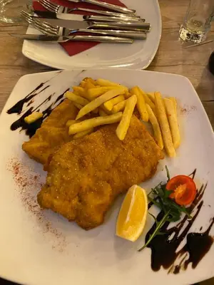 a plate of food with fish and french fries at Kopaonik Milmari P50 in Kopaonik