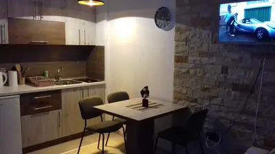 a kitchen with a table and chairs and a car on the wall at Kopaonik Milmari P50 in Kopaonik