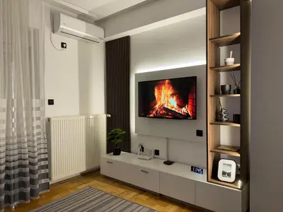 a living room with a fire on the wall at Apartman Filip2 in Kruševac