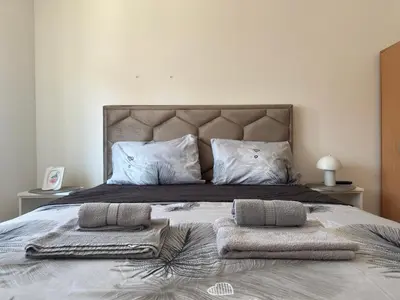 a bedroom with a bed with two towels on it at Apartman Filip2 in Kruševac
