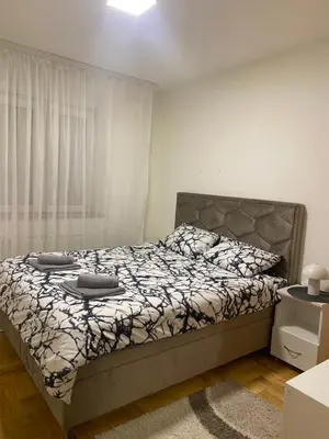 a bedroom with a bed and a window at Apartman Filip2 in Kruševac