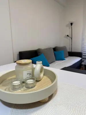 a table with a tray with two glass bowls on it at Apartman Filip2 in Kruševac