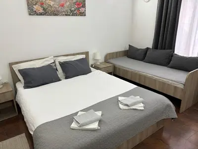 two beds in a room with towels on them at Apartments Ozren in Soko Banja