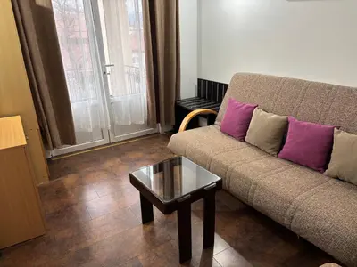 a living room with a couch and a coffee table at Apartments Ozren in Soko Banja