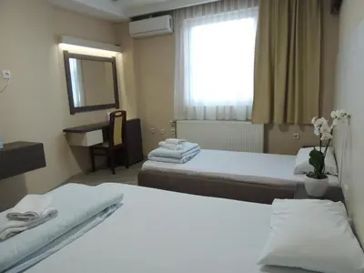 a hotel room with two beds and a window at Guest House Dabi in Kruševac