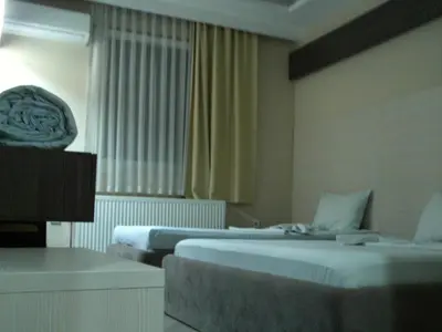 a hotel room with two beds and a window at Guest House Dabi in Kruševac