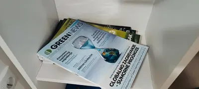 a drawer with two pieces of paper and a magazine at Golden Roses Apartment in Niš